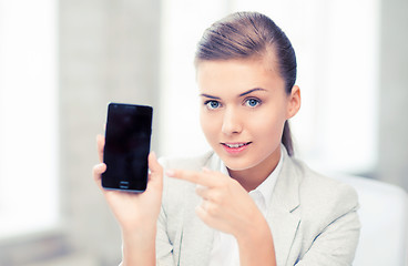 Image showing businesswoman with smartphone in office