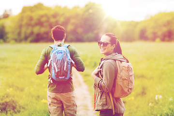 Image showing happy couple with backpacks hiking outdoors