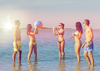 Image showing smiling friends in sunglasses on summer beach