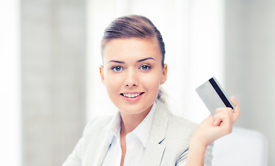 Image showing smiling businesswoman showing credit card