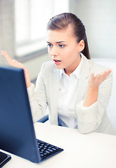 Image showing stressed student with computer in office