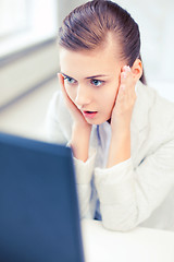 Image showing stressed businesswoman with computer