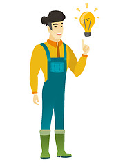 Image showing Farmer pointing at bright idea light bulb.