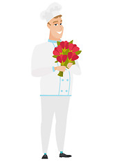 Image showing Caucasian chef cook holding a bouquet of flowers.