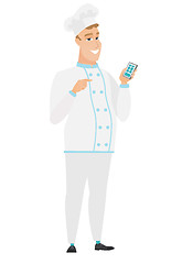 Image showing Caucasian chef cook holding a mobile phone.