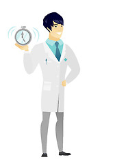 Image showing Asian doctor holding alarm clock.