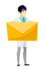 Image showing Smiling doctor holding a big envelope.