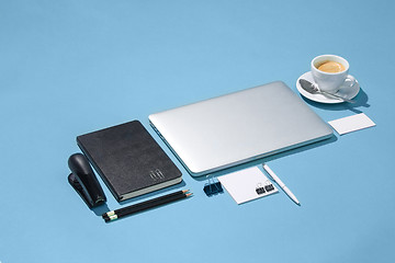 Image showing The laptop, pens, phone, note with blank screen on table