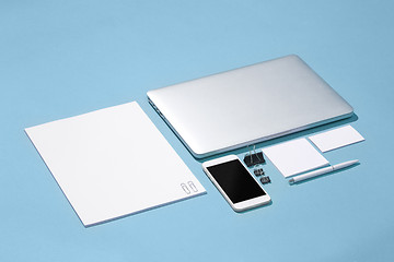 Image showing The laptop, pens, phone, note with blank screen on table