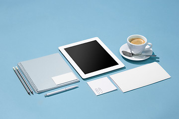 Image showing The laptop, pens, phone, note with blank screen on table