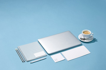 Image showing The laptop, pens, phone, note with blank screen on table