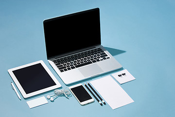 Image showing The laptop, pens, phone, note with blank screen on table