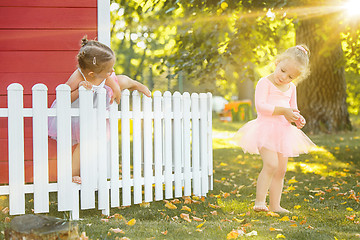 Image showing The two little girls at playground against park or green forest