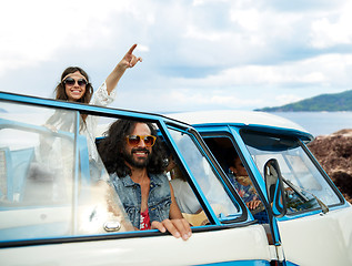 Image showing happy hippie friends in minivan car on island