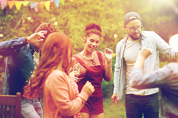 Image showing happy friends dancing at summer party in garden