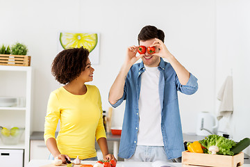 Image showing happy couple cooking food and having fun at home