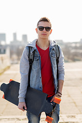 Image showing happy young man or teenage boy with longboard