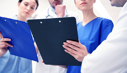 Image showing close up of doctors with clipboard at hospital