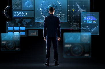 Image showing businessman looking at virtual screen from back