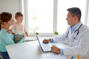 Image showing woman with baby and doctor with laptop at clinic