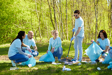 Image showing volunteers with garbage bags cleaning park area