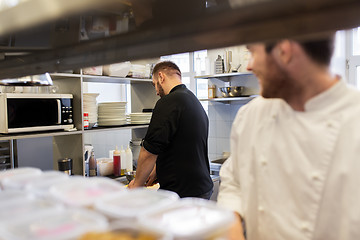 Image showing chef and cook cooking food at restaurant kitchen