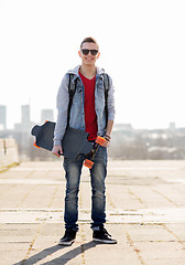 Image showing happy young man or teenage boy with longboard