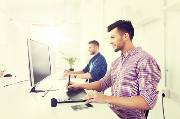 Image showing man or designer with computer and tablet at office