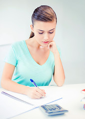 Image showing student girl with notebook and calculator