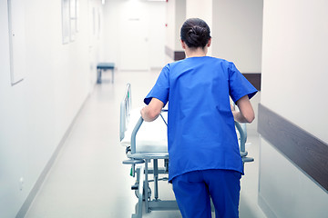 Image showing nurse carrying hospital gurney to emergency room