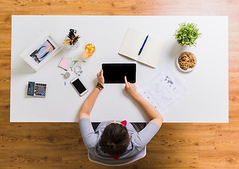 Image showing woman with tablet pc and notebook at office table