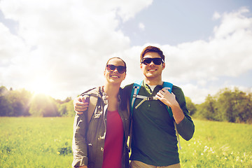 Image showing happy couple with backpacks hiking outdoors