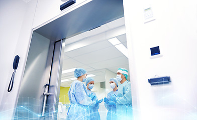 Image showing group of surgeons in operating room at hospital