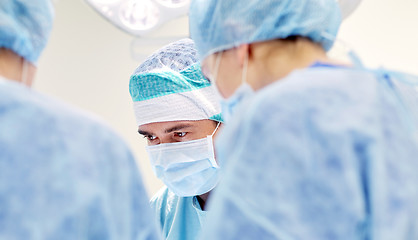 Image showing group of surgeons in operating room at hospital