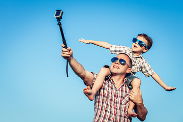 Image showing Father and son playing in the park  at the day time. 