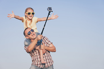 Image showing Father and daughter playing in the park  at the day time.