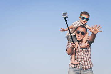 Image showing Father and son playing in the park  at the day time.