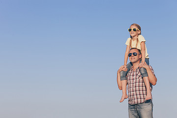 Image showing Dad and daughter in sunglasses playing in the park at the day ti