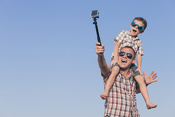 Image showing Father and son playing in the park  at the day time.