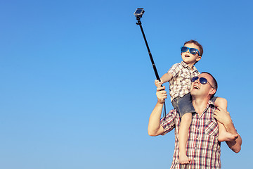 Image showing Father and son playing in the park  at the day time.