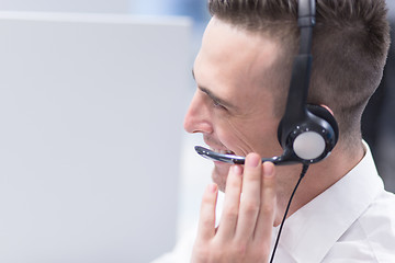 Image showing male call centre operator doing his job