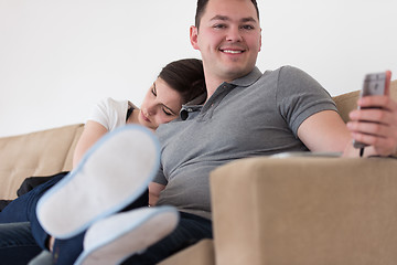 Image showing young couple hugging on the sofa