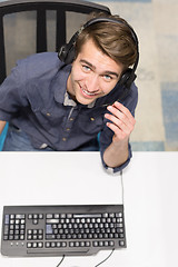 Image showing male call centre operator doing his job top view