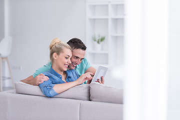 Image showing couple relaxing at  home with tablet computers