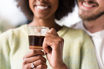 Image showing happy multiethnic couple relaxing at modern home indoors