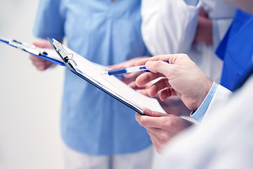 Image showing close up of doctors with clipboard at hospital