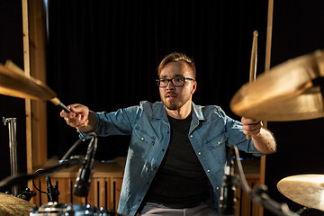 Image showing male musician playing drums and cymbals at concert