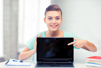 Image showing smiling student girl with laptop at school