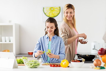 Image showing happy family cooking salad at home kitchen