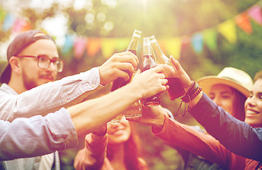 Image showing happy friends clinking glasses at summer garden